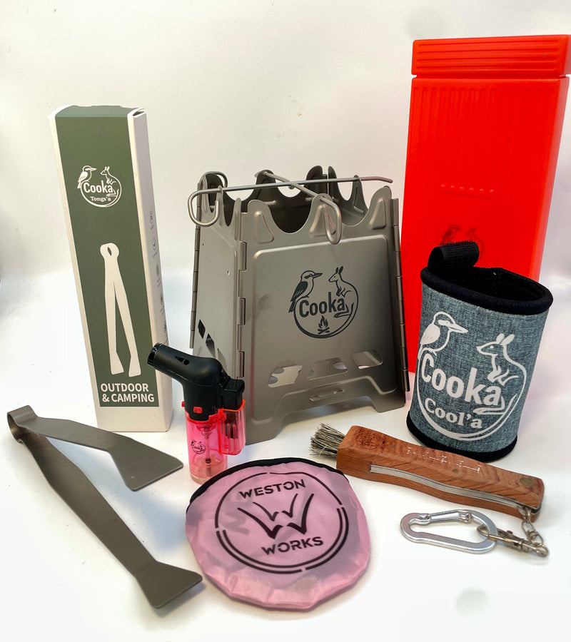 Cooka Hiker Kit: titanium folding camp stove, titanium tongs, Light'a lighter, Cut'a paring knife with brush, Cool'a stubby holder and Frisbee Fire Fan