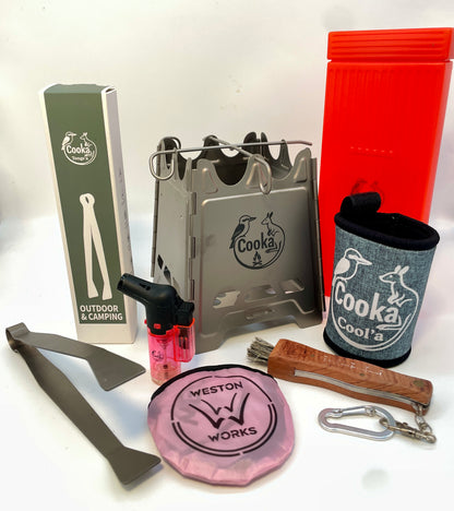 Cooka Hiker Kit: titanium folding camp stove, titanium tongs, Light'a lighter, Cut'a paring knife with brush, Cool'a stubby holder and Frisbee Fire Fan